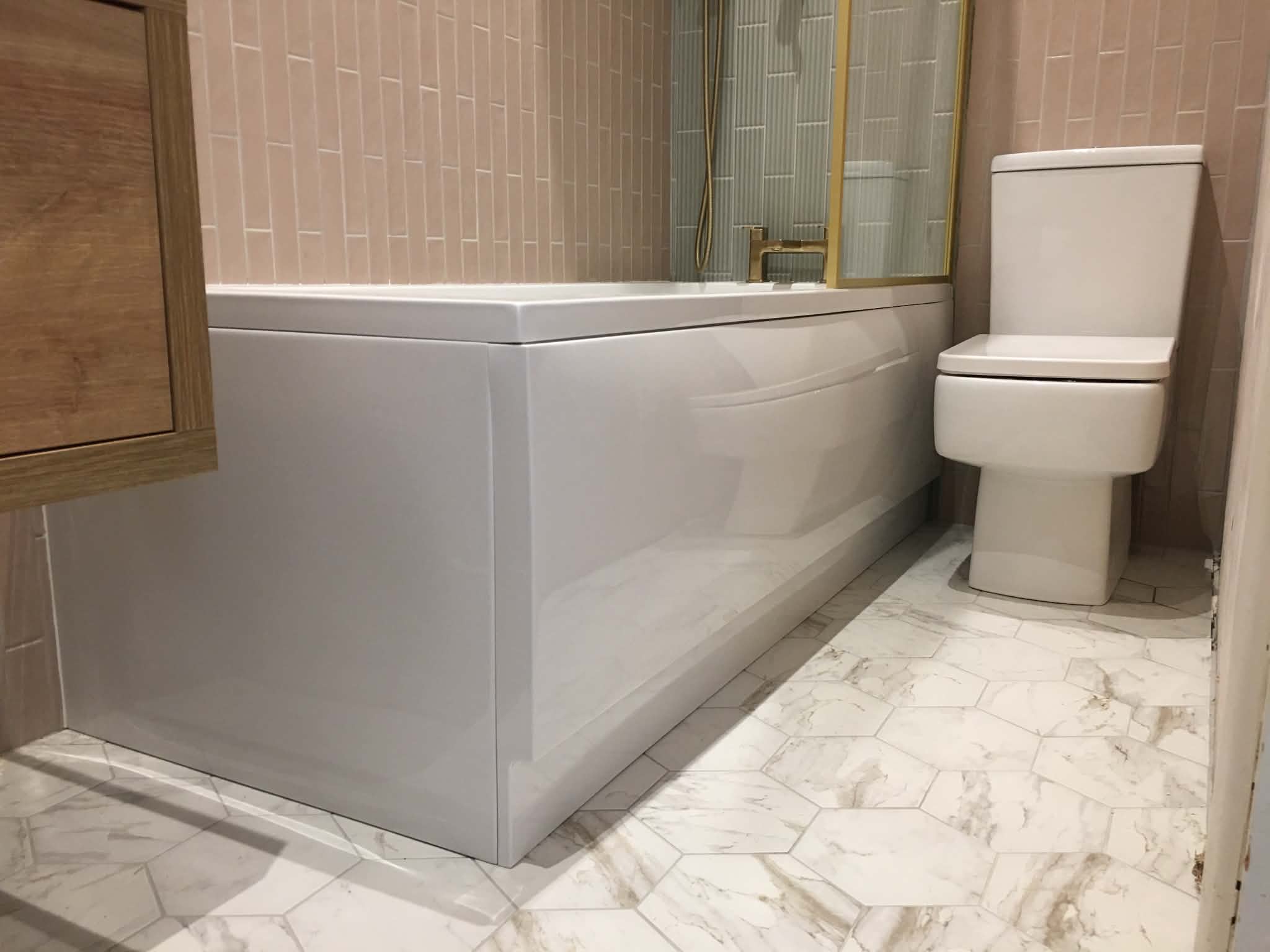 Bathroom with marble floor and gold fittings